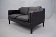 EVA 2 seater sofa in black leather on oak legs