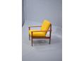 Elegant and comfortable armchair in teak and bright yellow upholstery