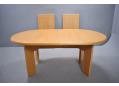 Oval top dining table in oak with 2 self-stored leaf extensions