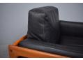Black leather upholstered cushions on Komfort armchair by H W Klein.