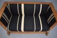 Antique trunk sofa with carved side pannels and wrought iron handles 