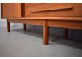 The sideboard stands securely on a leg frame.