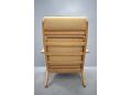 High back plank chair designed by Hans Wegner in beige fabric upholstery.