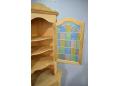 Coloured glass panel door on HM Mobler corner cabinet in oak.