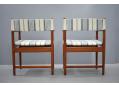 Frames are made of teak contrasted by the striped fabric upholstery.