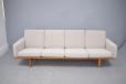4 seat settee with light oak frame & fabric upholstery.
