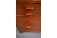 Solid teak handles allow for easy access to the drawer storage.
