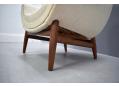Teak legs contrasted by the cream colour fabric upholstery.
