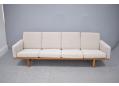 4 seat settee with light oak frame & fabric upholstery.