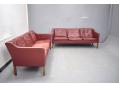 Low back 3 seat sofa made in Denmark with burgundy leather upholstery.