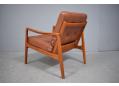 Midcentury classic designed armchair with tan leather cushions. Ole Wanscher 
