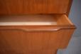 Lipped teak handles are fitted on the top of each drawer front.