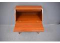 Each drawer is fitted with a pair of brass handles