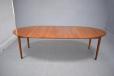 Fully extended oval dining table in rosewood. Able to seat 8-10 