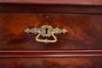 Each drawer bears a elegantly design brass handle